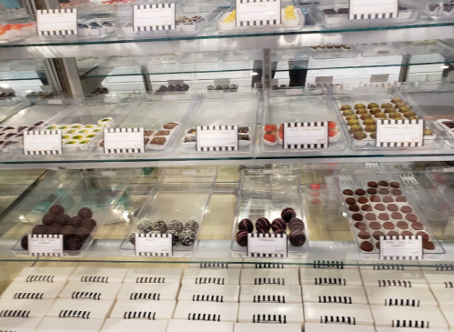 A display case filled with assorted chocolates and confections in various shapes and colors.