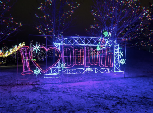 Colorful holiday lights form a sign that says "I ❤️ Duluth" against a dark, snowy background.