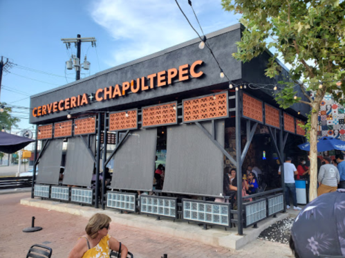 Exterior of Cerveceria Chapultepec, a lively restaurant with outdoor seating and a modern design.