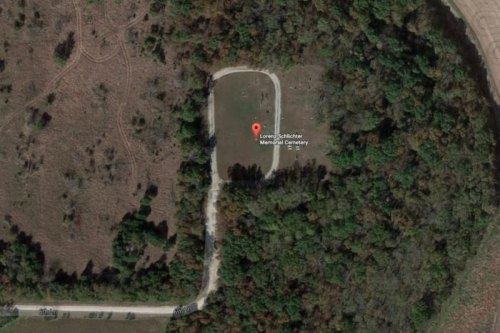 Aerial view of Lorenz Schlochter Memorial Cemetery surrounded by trees and open land.