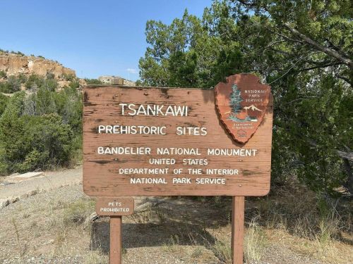 Sign for Tsankawi Prehistoric Sites at Bandelier National Monument, featuring the National Park Service logo.