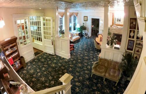 A cozy lobby with patterned carpet, seating areas, and large windows, featuring a welcoming atmosphere.