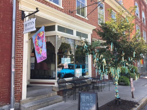 Exterior of Betty's Restaurant with colorful decorations, outdoor seating, and a welcoming sign.