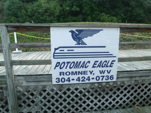 Sign for Potomac Eagle in Romney, WV, featuring a stylized eagle and contact information.
