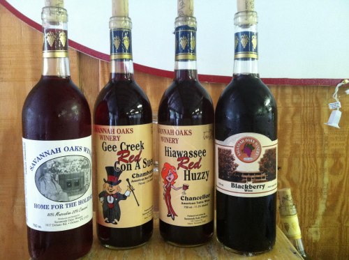 Four bottles of wine with colorful labels, featuring names like "Savannah Oaks," "Gee Creek," and "Blackberry."