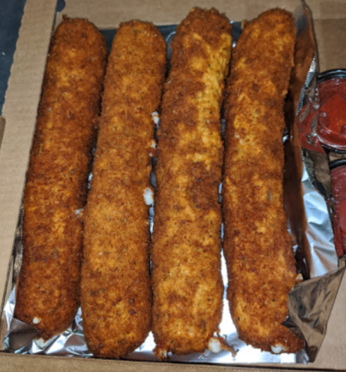 Four golden-brown, breaded mozzarella sticks arranged in a box, accompanied by a small container of marinara sauce.