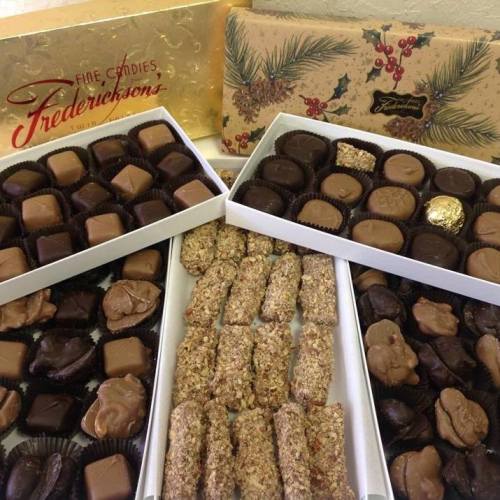 An assortment of chocolates and candies in decorative boxes, featuring various shapes and flavors.