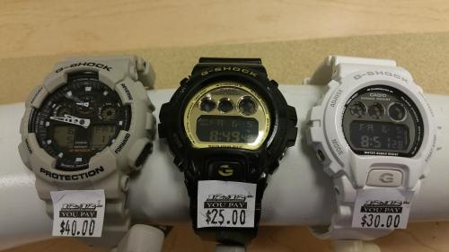Three Casio G-Shock watches displayed on a stand, with price tags: $40, $25, and $30.