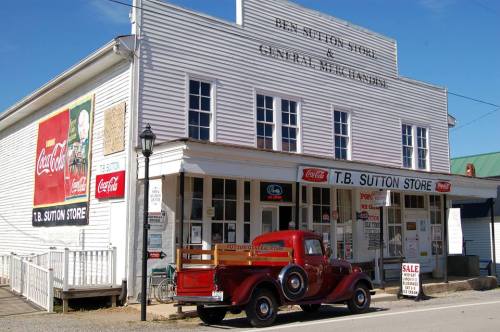 Historic T.B. Sutton Store with a vintage red truck parked outside, featuring Coca-Cola advertisements on the building.
