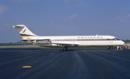 A Southern Airlines jet on the tarmac, showcasing its classic livery against a clear blue sky.
