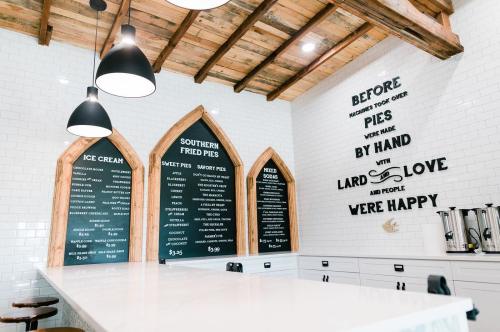 Interior of a cozy eatery featuring a menu board for ice cream and southern fried pies, with rustic wooden accents.