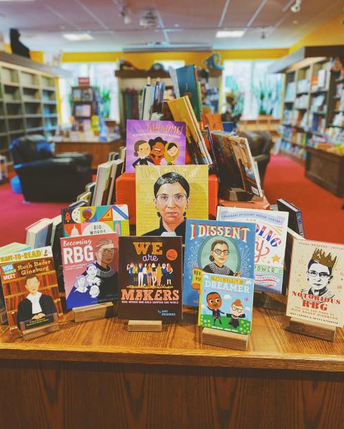 A colorful display of children's books featuring diverse characters and themes, set in a cozy bookstore.