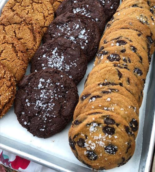 A tray of assorted cookies: brown sugar, chocolate, and chocolate chip, topped with sea salt.