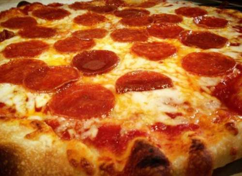 A close-up of a pepperoni pizza with melted cheese and a golden crust.