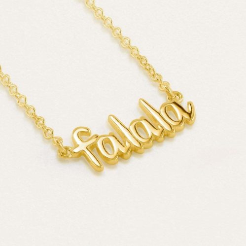 Gold necklace featuring the word "falala" in a playful, cursive font on a light background.