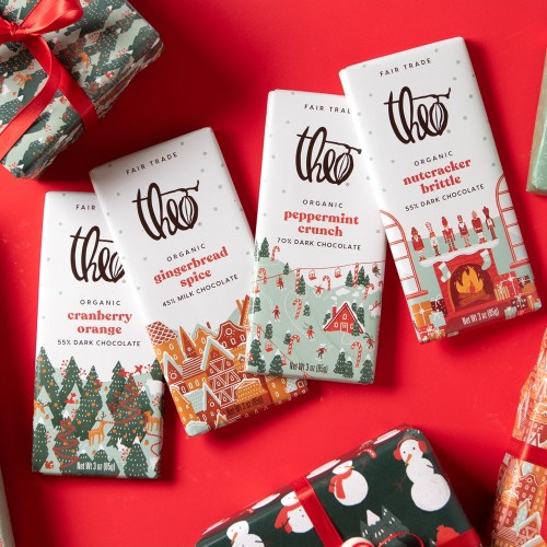 Three colorful chocolate bars on a red background, featuring festive flavors: cranberry orange, gingerbread spice, and peppermint crunch.