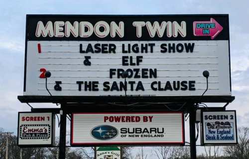 Sign for Mendon Twin Drive-In featuring movies: "Laser Light Show," "Elf," "Frozen," and "The Santa Clause." Powered by Subaru.