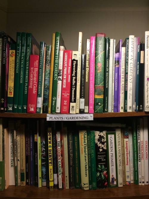 A bookshelf filled with various gardening and plant-related books, labeled "Plants / Gardening."