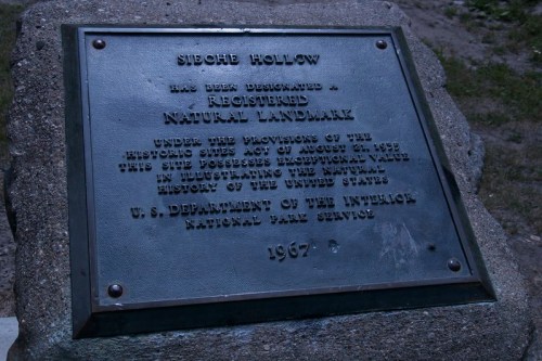 Plaque marking Sieche Hollow as a registered natural landmark, detailing its historical significance. U.S. Department of the Interior.