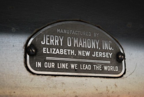 Metal nameplate reading "Manufactured by Jerry O'Mahony, Inc., Elizabeth, New Jersey. In our line we lead the world."