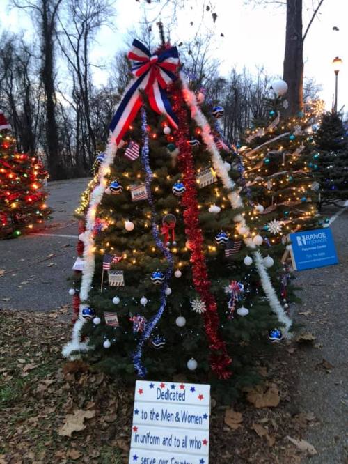 A decorated Christmas tree with red, white, and blue ornaments, honoring men and women in uniform.