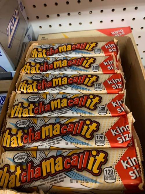 A box of Whatchamacallit candy bars stacked neatly, showcasing their colorful wrappers.