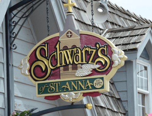 Sign for "Schwarz's of St. Anna," featuring a church design and established date of 1957.