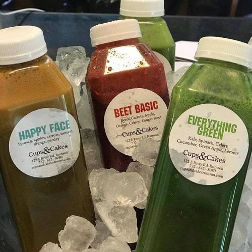 Four juice bottles on ice: Happy Face (green), Beet Basic (red), and Everything Green (dark green), all labeled with ingredients.