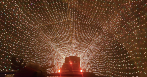 A tunnel illuminated with colorful holiday lights, creating a festive and enchanting atmosphere.