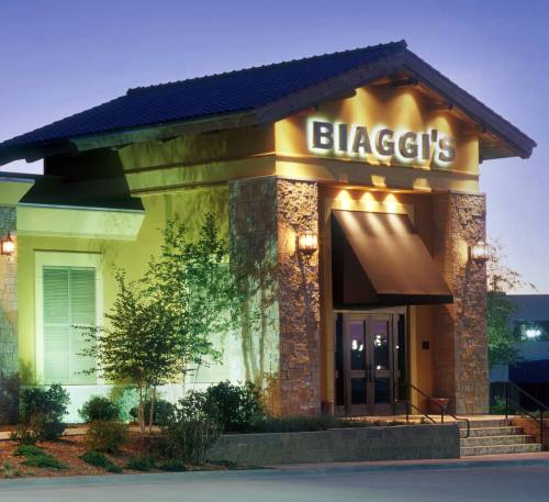 Exterior of Biaggi's restaurant at dusk, featuring stone accents and warm lighting.