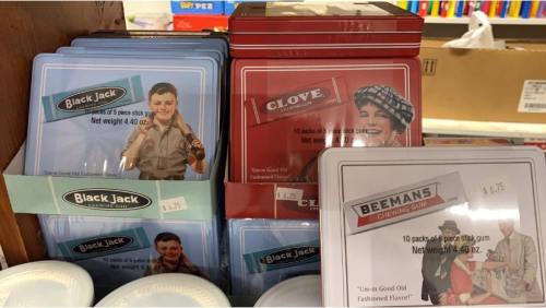 Vintage gum packaging displayed on a shelf, featuring Black Jack, Clove, and Beeman's chewing gum.