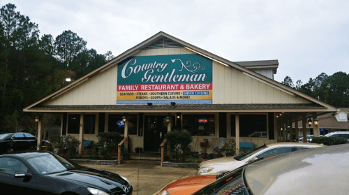 Exterior of Country Gentleman Family Restaurant & Bakery, featuring a sign with various cuisine offerings and an "Open" notice.