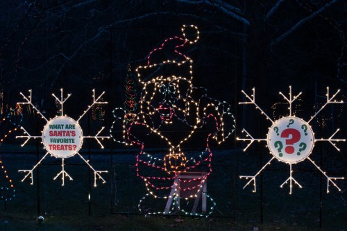 A festive display featuring a lit-up Santa and signs asking about his favorite treats, surrounded by snowflake decorations.