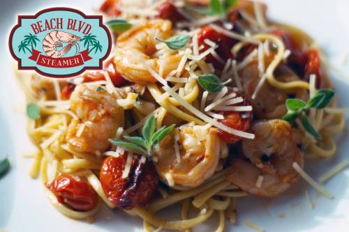 A plate of shrimp pasta with tomatoes and herbs, topped with cheese, alongside a logo for Beach Blvd Steamer.