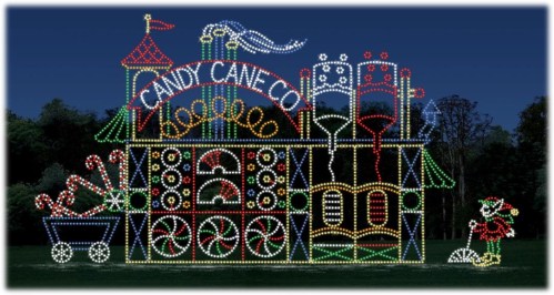 Colorful holiday light display featuring a whimsical candy cane factory with candy canes and festive decorations.
