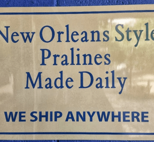 Sign advertising "New Orleans Style Pralines Made Daily" with a note that they ship anywhere.