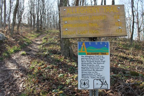 Signpost for the Allegheny Trail, indicating distances to Hanging Rock Lookout, Appalachian Trail, and Sugar Camp Farm.
