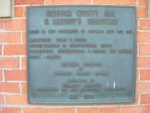 Plaque detailing the history of Steuben County Jail and Sheriff's Residence, built in 1877, with dedication information.