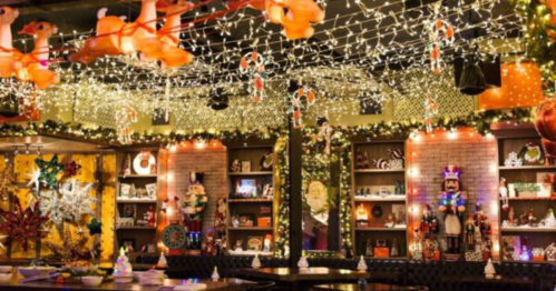 A festive restaurant interior decorated with Christmas lights, ornaments, and holiday-themed displays.