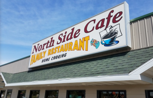 Sign for "North Side Cafe" featuring "Family Restaurant" and "Home Cooking" in colorful lettering.