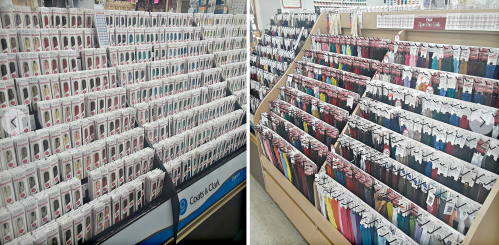A store display featuring rows of colorful sewing threads in various shades, neatly organized on shelves.
