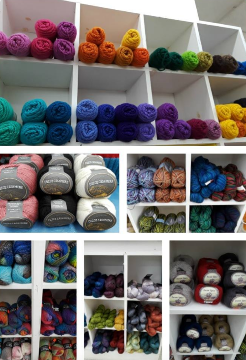 A display of colorful yarns organized in shelves, featuring various shades and textures in neat rows.