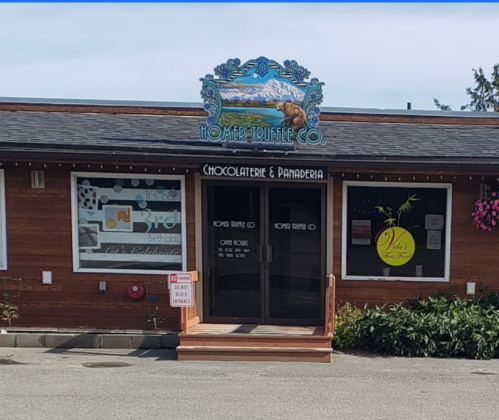 Front view of Homer Truffle Co. featuring a sign, windows with decorative displays, and a welcoming entrance.