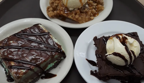 Three dessert plates: a chocolate mint cake, a warm apple crumble with ice cream, and a chocolate brownie with ice cream.
