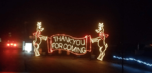 A festive display featuring two illuminated reindeer beside a banner that reads "THANK YOU FOR COMING."