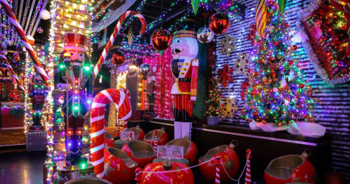 A festive room decorated with colorful lights, nutcrackers, candy canes, and a Christmas tree.