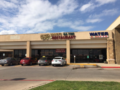 Exterior of a restaurant with a sign reading "Ginger Brown's Old Tyme Restaurant" and a "Water & Gifts" store nearby.