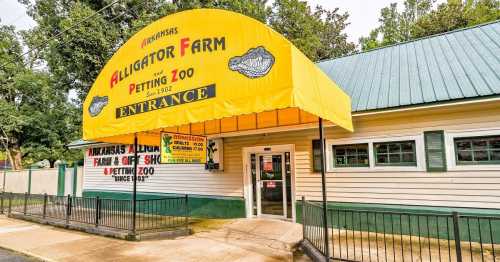 Bright yellow entrance of the Arkansas Alligator Farm and Petting Zoo, featuring signage and a welcoming facade.