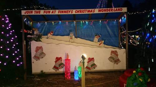 A festive display at Finney's Christmas Wonderland with snowmen, colorful lights, and holiday decorations.