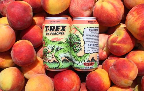 Two cans of "T-Rex on Peaches" beer surrounded by fresh peaches, featuring a colorful dinosaur illustration.